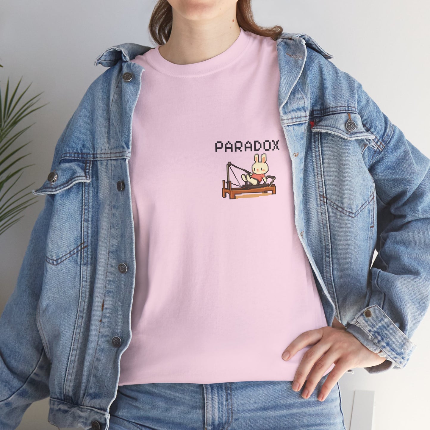 Pink t-shirt with a graphic pixel art of bunny doing pilates on a female model