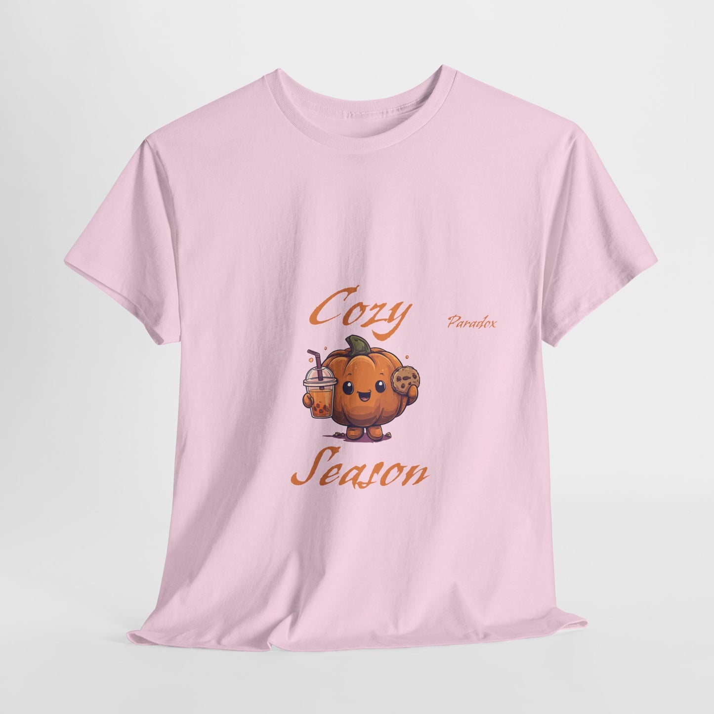Pink t-shirt of a graphic cute cozy season pumpkin holding a cookie and pumpkin spice