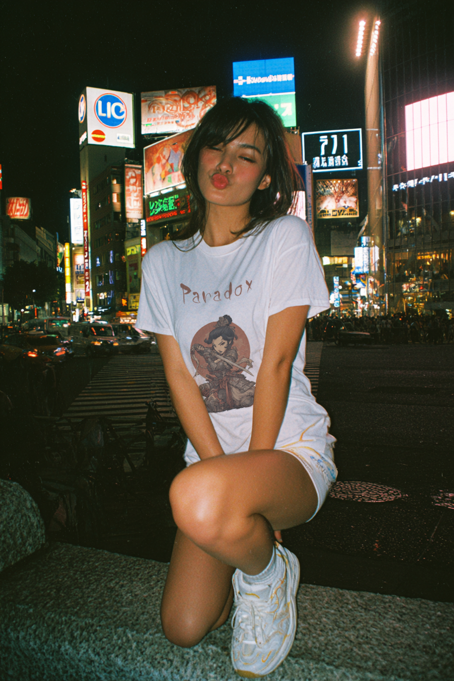 White t-shirt with a graphic of a warrior featuring a lady samurai on a female model